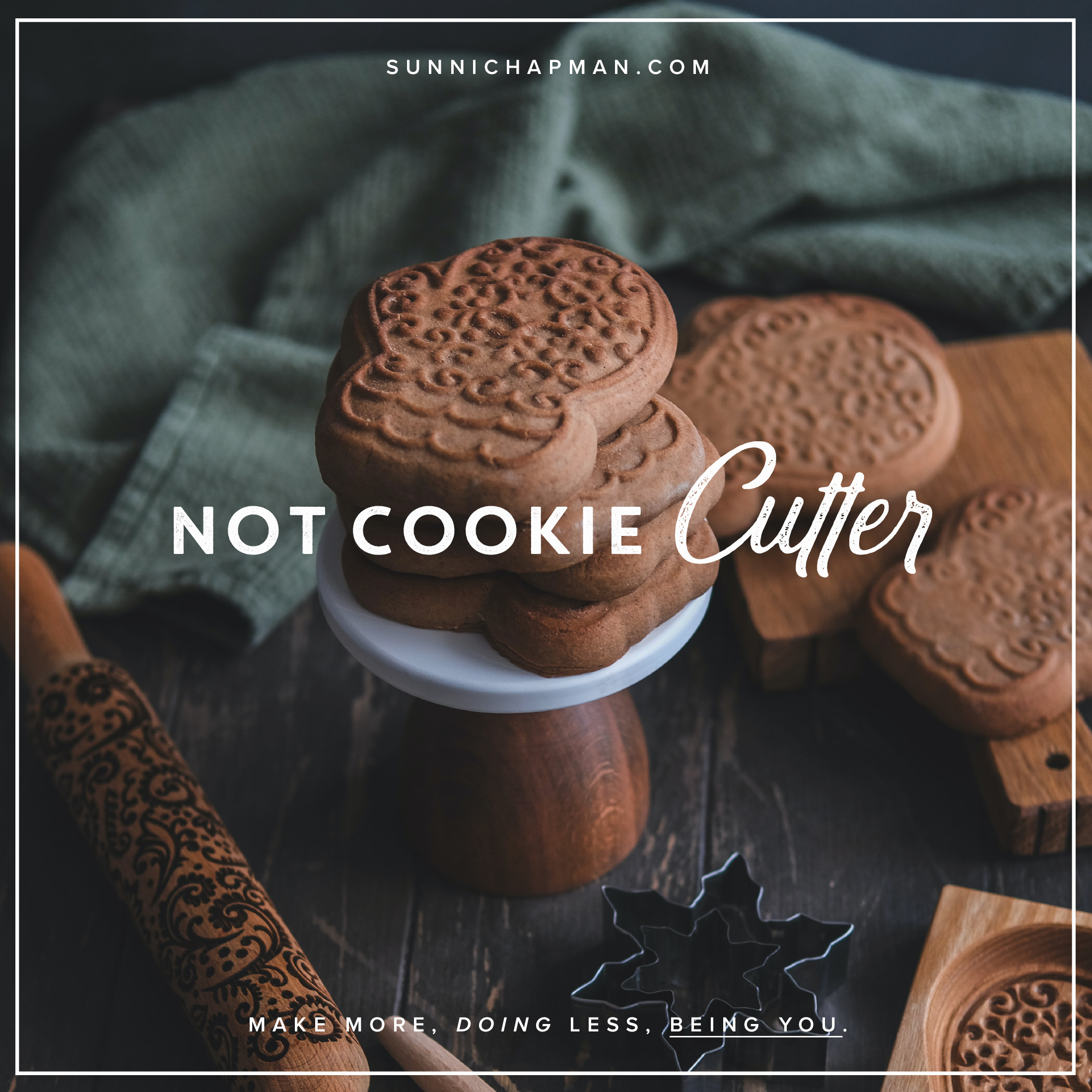 Promotional graphic for SunniChapman.com featuring a stack of ornate cookies with embossed designs on a cake stand, next to a carved rolling pin and cookie cutters on a wooden surface. The text 'Not Cookie Cutter' is prominently displayed with the tagline 'Make more, doing less, being you.' A green cloth adds a contrasting background